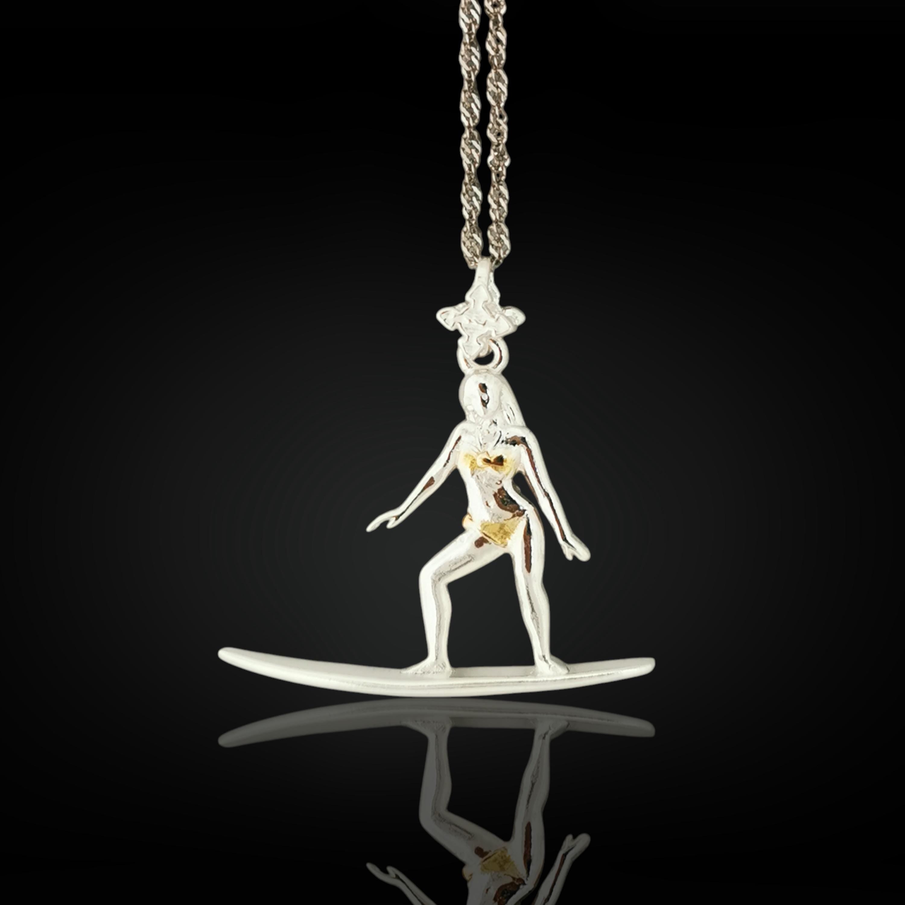 Gold-plated surf girl necklace handcrafted from solid 925 sterling silver — a radiant pendant celebrating sun-kissed waves, freedom, and feminine spirit.
This design captures a woman in motion atop her surfboard — elegant, balanced, and unstoppable. The polished gold finish brings warmth and coastal glamour, evoking memories of endless summer and ocean serenity. A meaningful gift for those who chase waves and live by the tide.