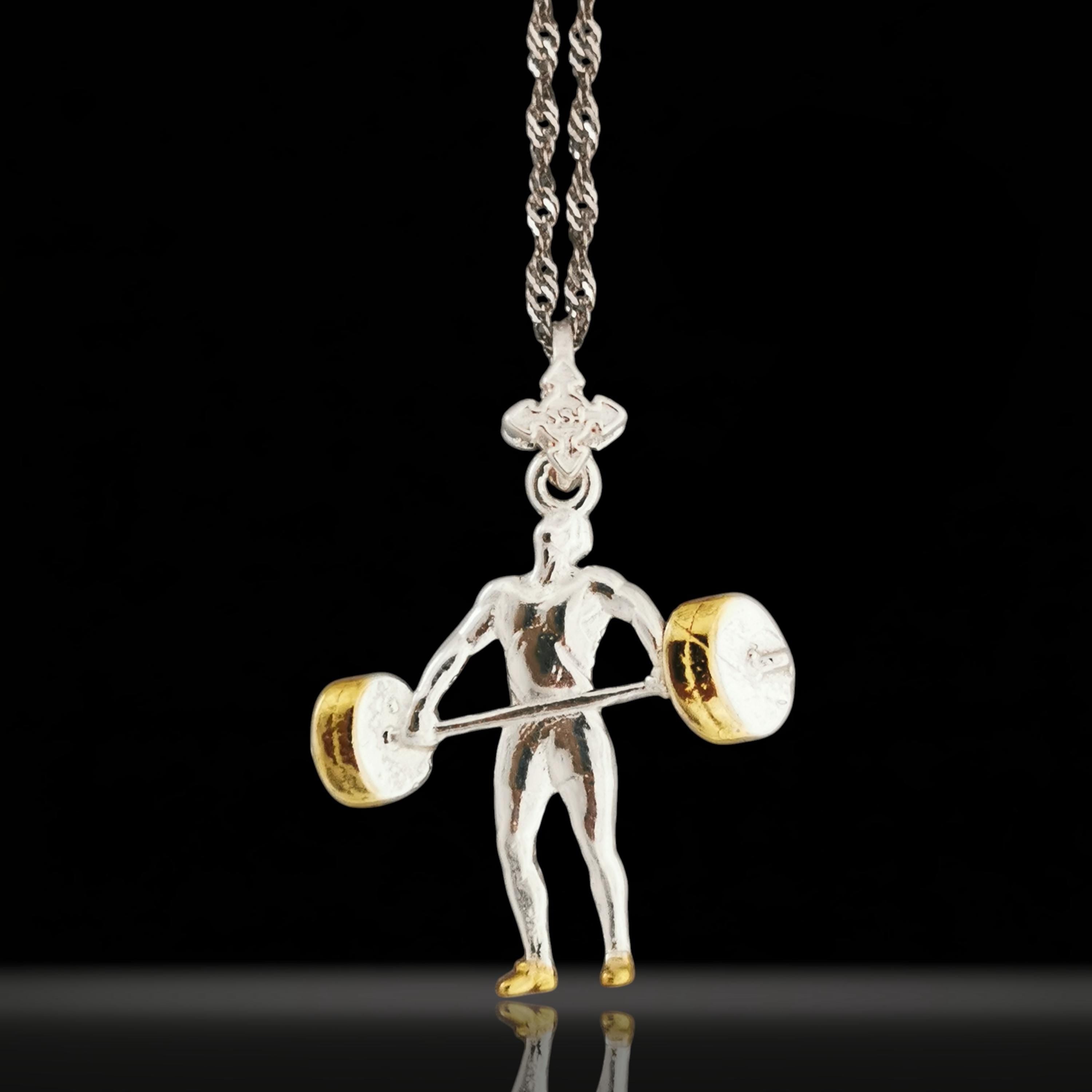 Two-tone weightlifting necklace for men – crafted from solid 925 sterling silver with gold-plated detail. A bold pendant honoring the discipline, strength, and drive of serious athletes.
The design features a muscular figure mid-lift, capturing the explosive energy and control of weight training. The gold accent adds contrast and prestige, perfect for men who train hard and live with purpose.