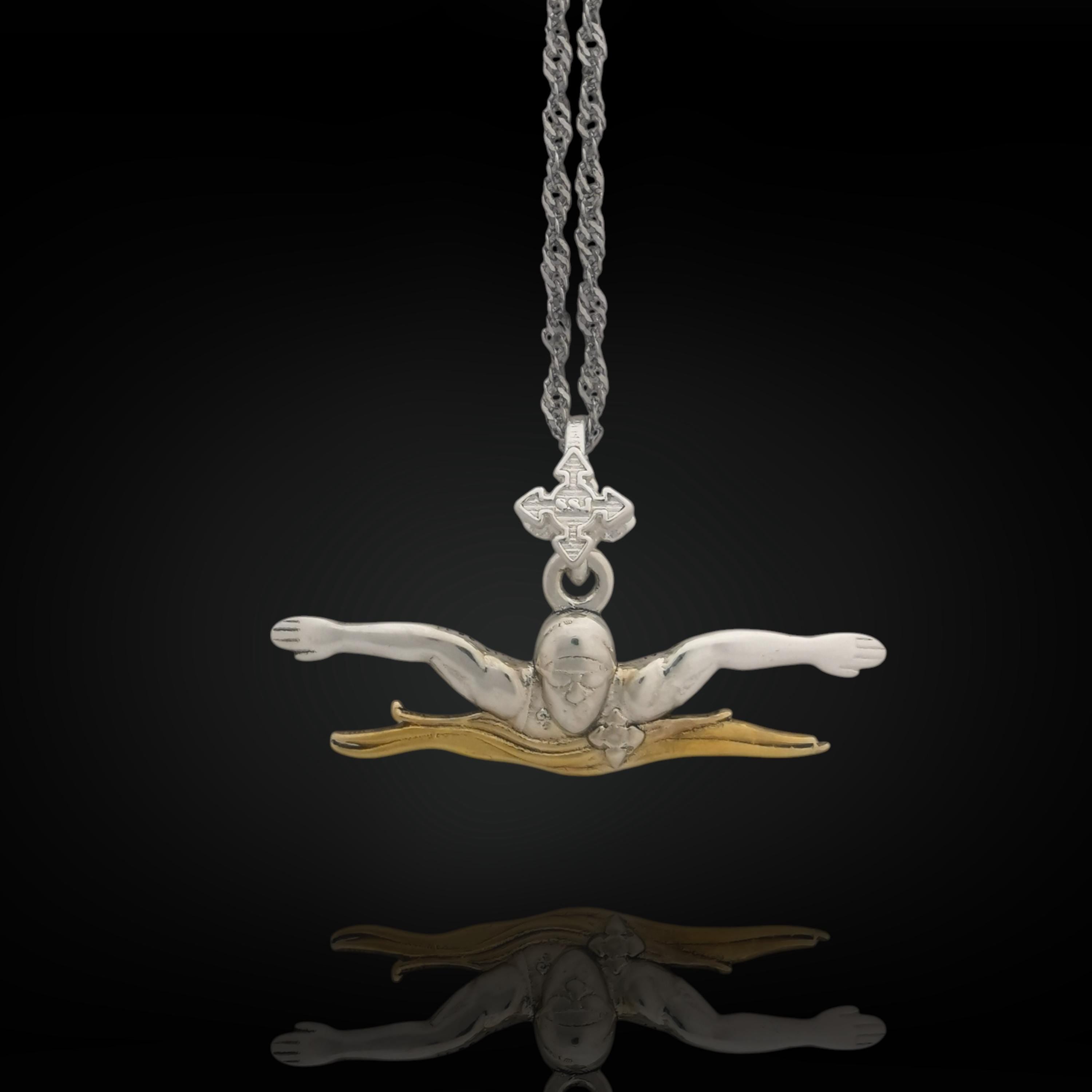 Two-tone butterfly swimming pendant handcrafted in solid 925 sterling silver with partial gold plating — a bold tribute to speed, motion, and the discipline of competitive swimming.
Featuring a male swimmer mid-butterfly stroke, this pendant captures precision and strength in every line. The gold-accented details enhance the figure's power and presence, creating a meaningful gift for swimmers, coaches, or fans of water sports and elegant design.