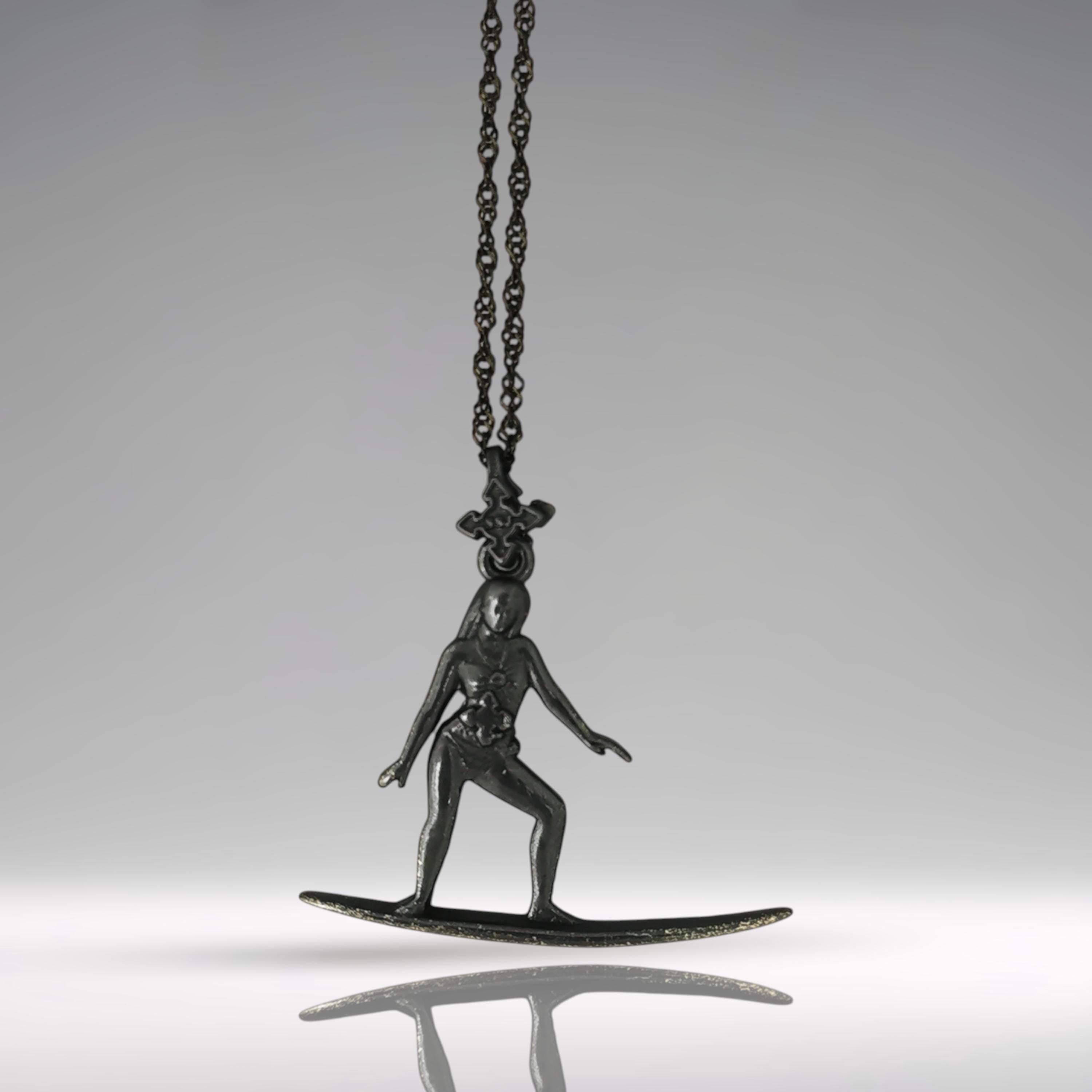 Black oxidized surf necklace handcrafted in solid 925 sterling silver — a sleek and soulful pendant celebrating the thrill of wave riding and the freedom of the open sea.
This expressive design captures a poised female surfer mid-ride, her body aligned with the board in perfect harmony. The dark matte finish adds mystery and edge, turning the piece into a powerful symbol of flow, balance, and untamed spirit. A tribute to women who live for the ocean breeze and move with fearless grace.