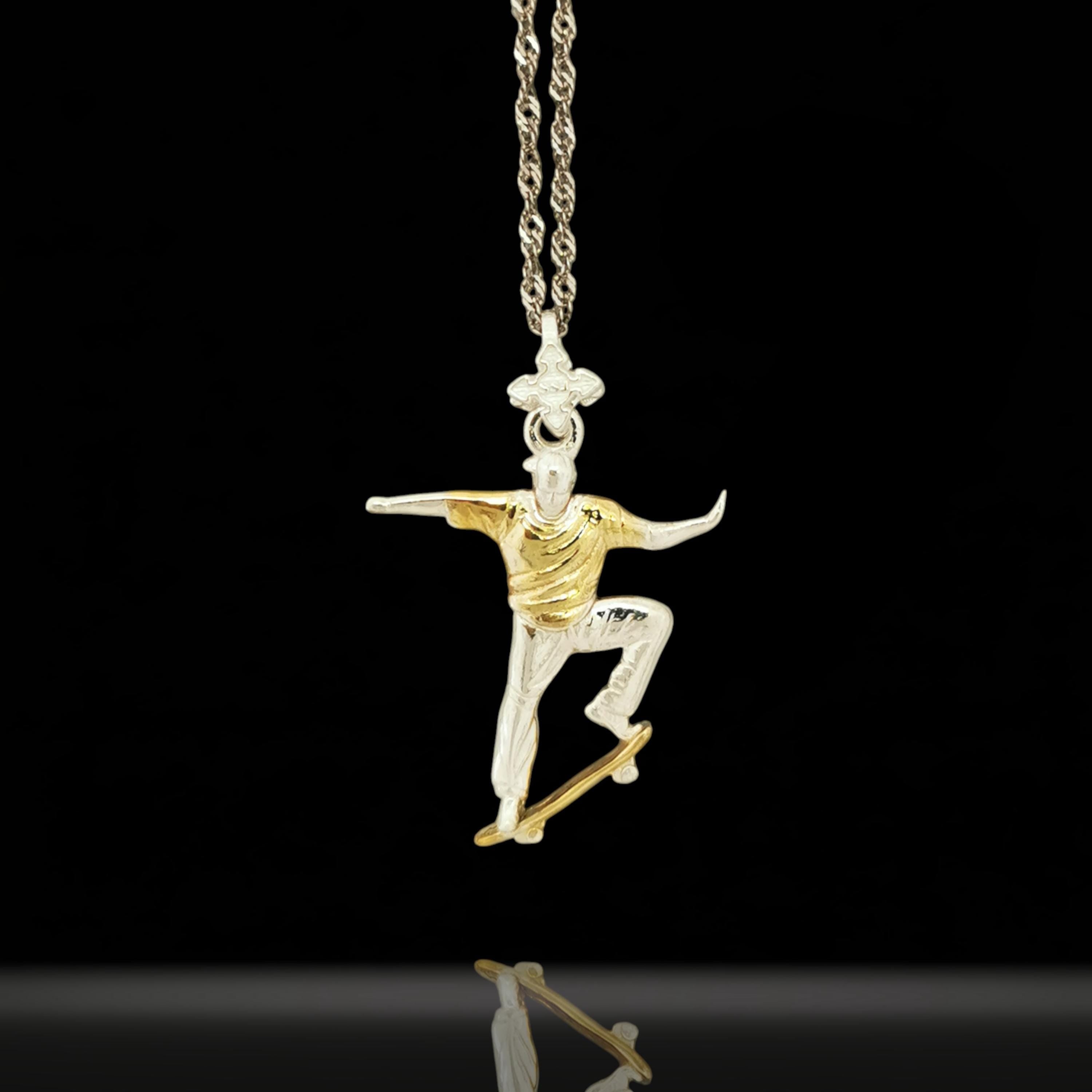 Two tone skateboard necklace for men and teen boys crafted from solid 925 sterling silver with partial gold plating – a bold and elegant streetwear pendant for skaters, freestyle athletes, and fans of expressive style. The contrast between polished silver and gold detail makes this piece stand out with purpose.
Handcrafted to reflect movement, identity, and personal energy, it’s more than jewelry – it’s a symbol of style, freedom, and fearless individuality.