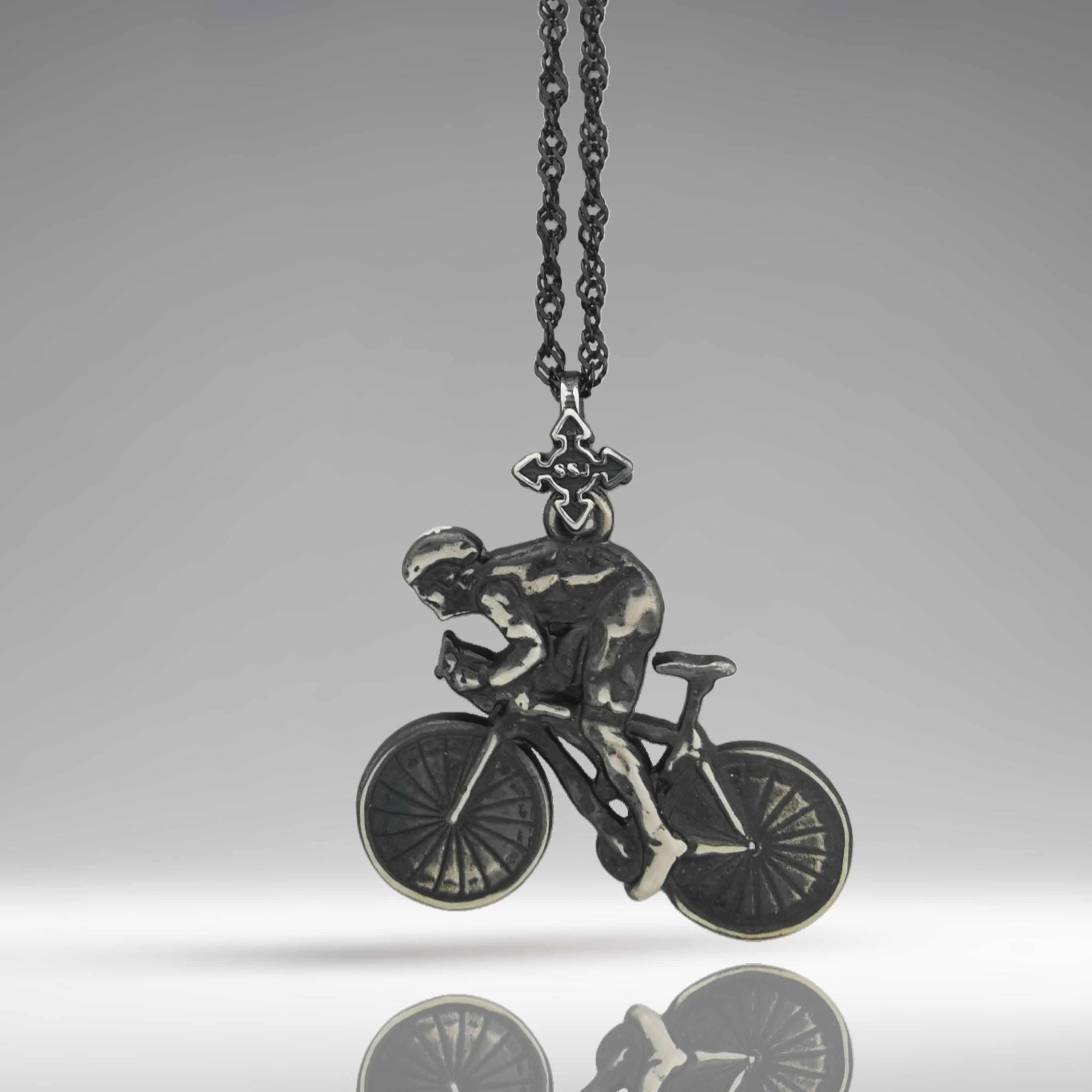 Vintage-style cycling pendant handcrafted from solid 925 sterling silver — a rugged and characterful accessory for men passionate about the ride. With its patinated finish and detailed design, it captures the essence of endurance, motion, and timeless strength.
This necklace features a cyclist in action, full of dynamic posture and grit — a wearable symbol of perseverance and power. A great piece for daily motivation or meaningful milestones.