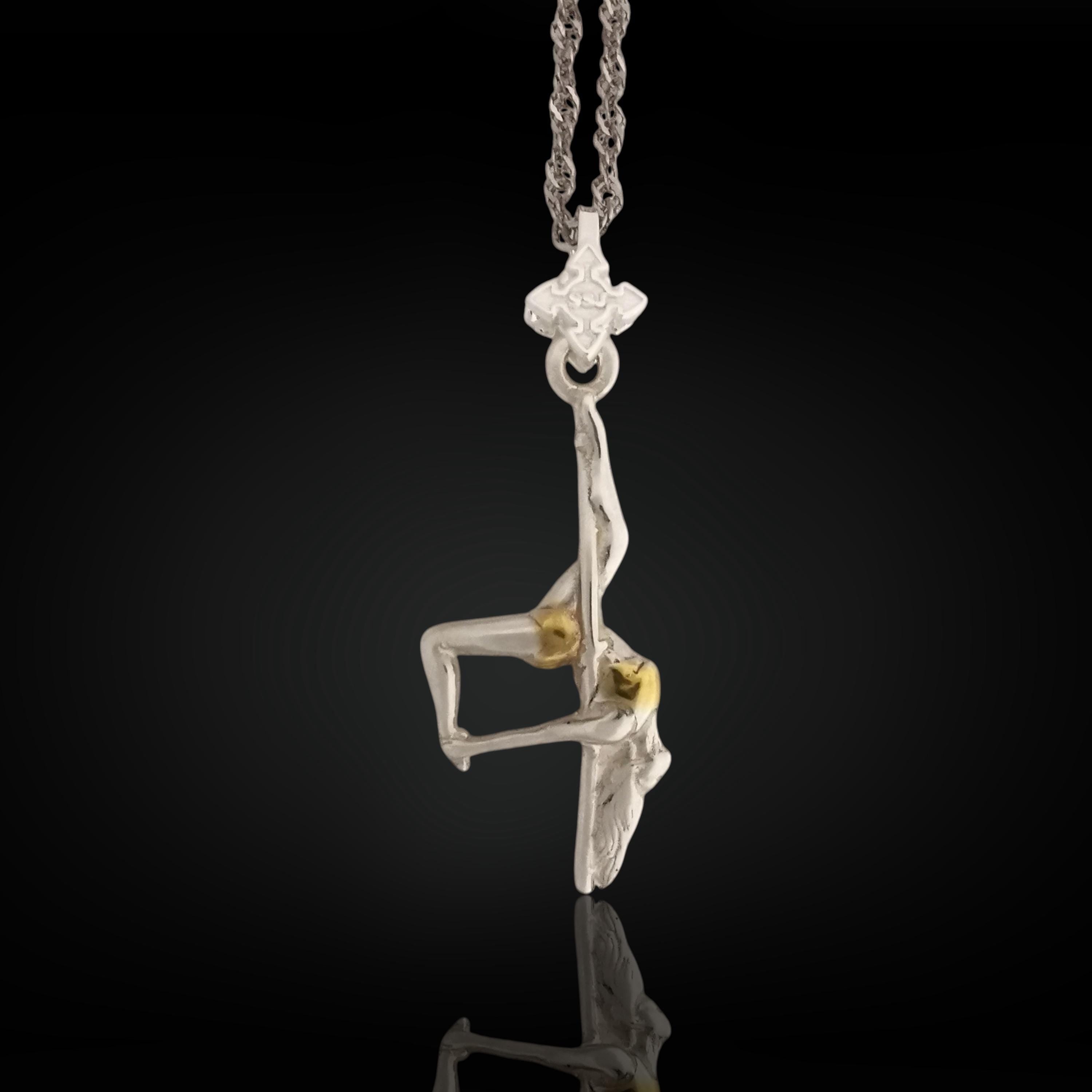 Two-tone pole dance necklace handcrafted in solid 925 sterling silver with elegant gold detailing — a refined and sensual pendant celebrating feminine strength and expressive beauty.
This design captures a dancer mid-performance, suspended upside down in an artistic pose. The contrast between silver and gold enhances the curves, grace, and emotion of the piece. A wearable tribute to confidence, bold movement, and the freedom of self-expression — on the stage or in everyday life.
