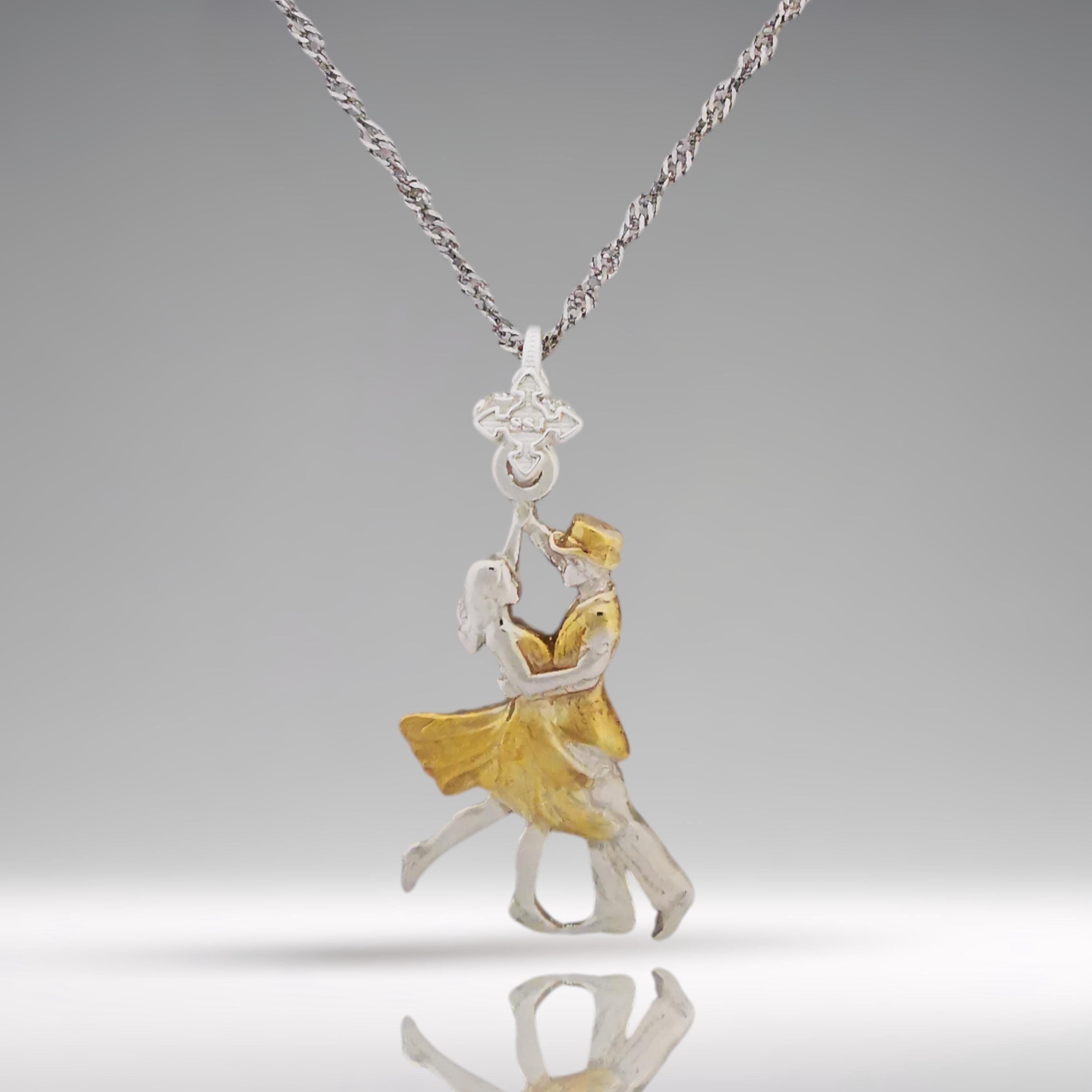 Looking for a romantic gift for her? This elegant two-tone tango pendant blends polished 925 sterling silver with graceful gold-plated accents — a tribute to the passion, precision, and connection found in Latin and ballroom dance.
The design features a dancing couple in fluid motion, symbolizing both the intensity of tango and the delicate harmony between strength and grace. The dual-metal finish adds timeless beauty and makes this piece