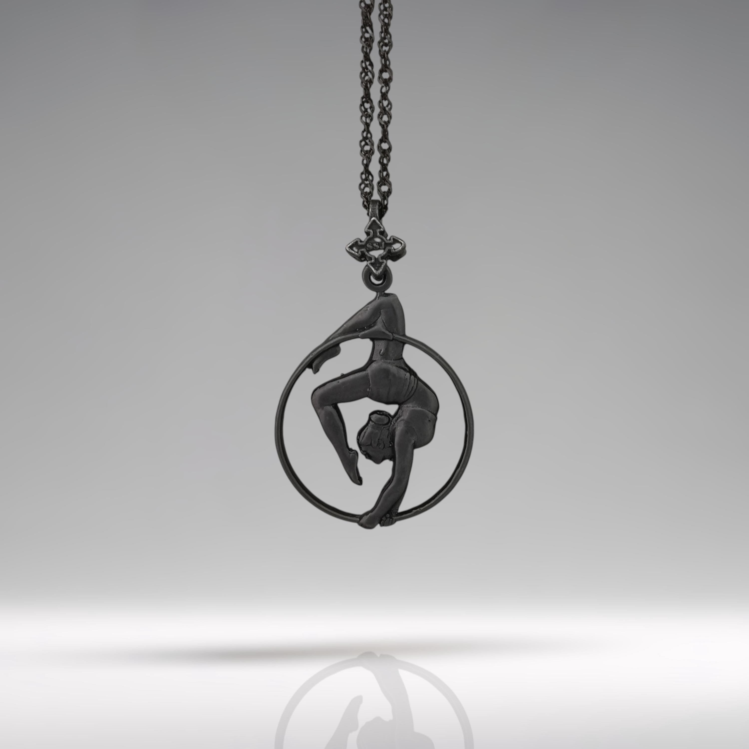 Black oxidized aerial hoop necklace crafted from solid 925 sterling silver — a dramatic and empowering pendant that celebrates aerial artistry, fluid motion, and fearless femininity.
This handcrafted piece features a woman in a graceful inverted pose within the hoop, capturing the strength, elegance, and poise of aerial dance. The deep matte black finish adds mystery and edge, transforming it into a bold symbol of control, beauty, and physical expression. Ideal for women who rise,