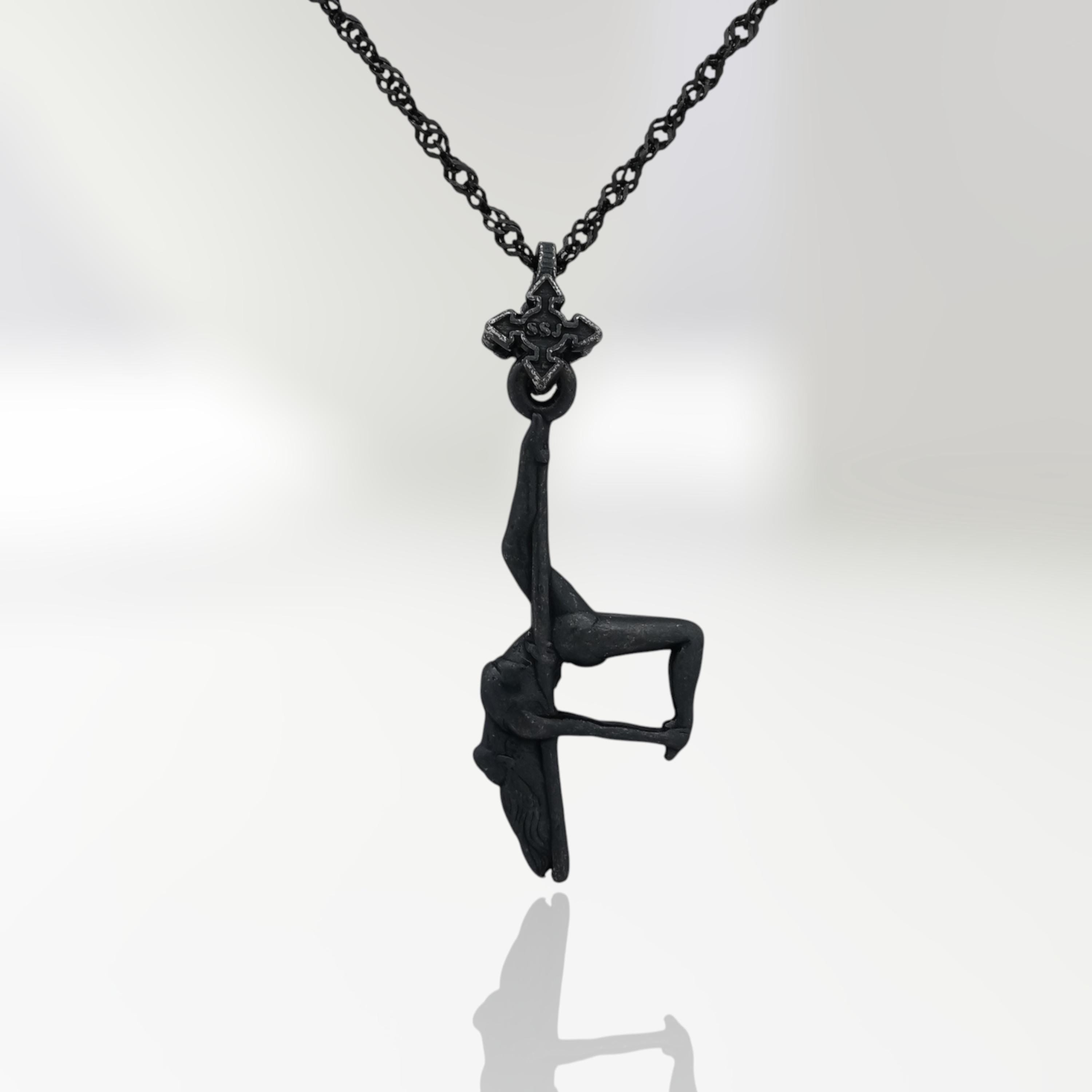 Black oxidized pole dance pendant in 925 sterling silver — a dark, expressive piece that radiates sensuality, mystery, and feminine confidence.
This handcrafted design captures a pole dancer mid-performance in an inverted pose, full of raw energy and erotic tension. The matte black finish adds a bold urban edge to her graceful curves, turning every line into a statement. A celebration of power, elegance, and fearless femininity — perfect for those who own their movement and identity.
