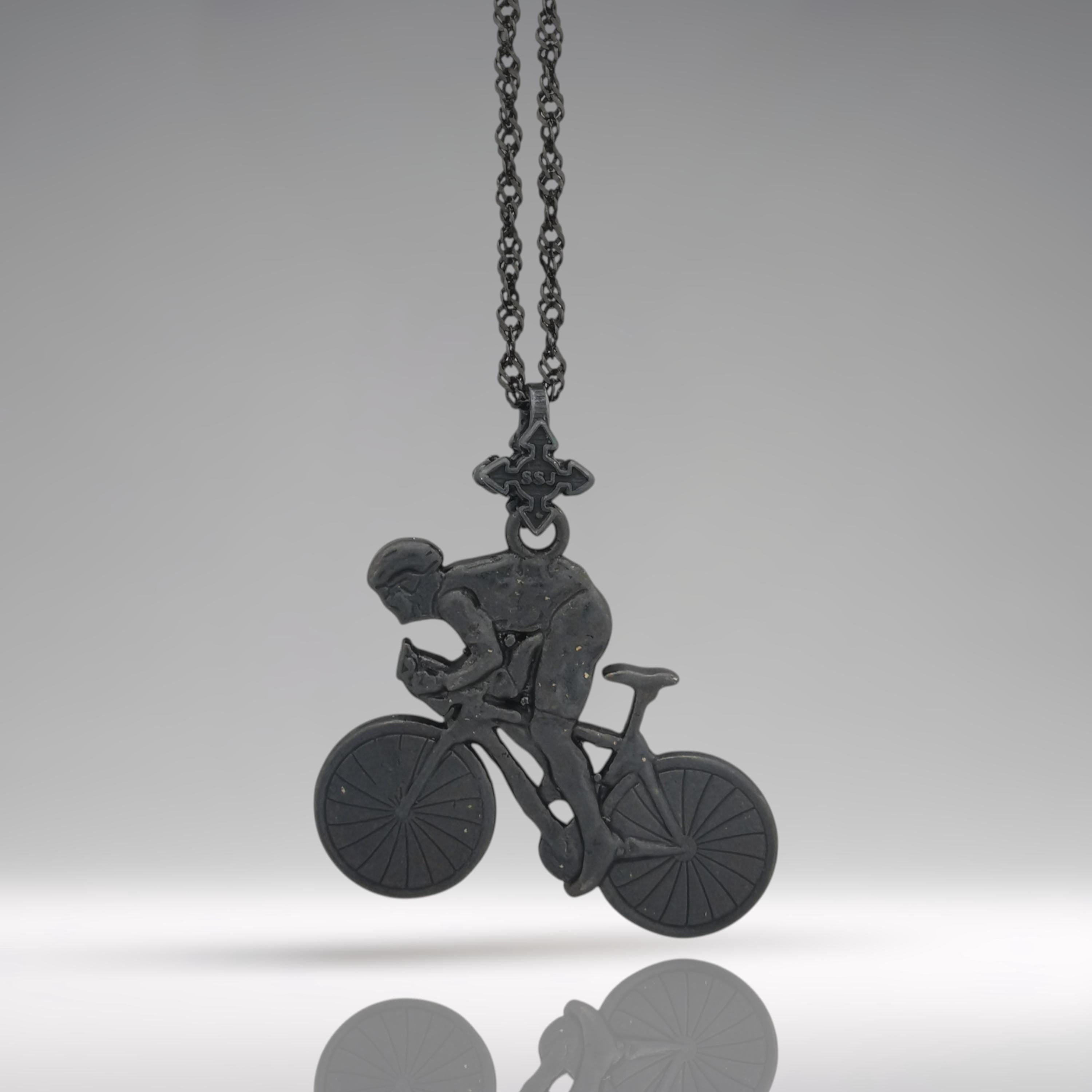 Oxidized black cyclist necklace handcrafted from solid 925 sterling silver — a bold and dynamic pendant designed for men who live to ride. This detailed piece captures a rider mid-sprint on an aerodynamic road bike, celebrating strength, speed, and focus.

The rugged black finish enhances the powerful silhouette, making it ideal for passionate cyclists, racers, or triathletes. A statement of dedication and freedom on two wheels.
